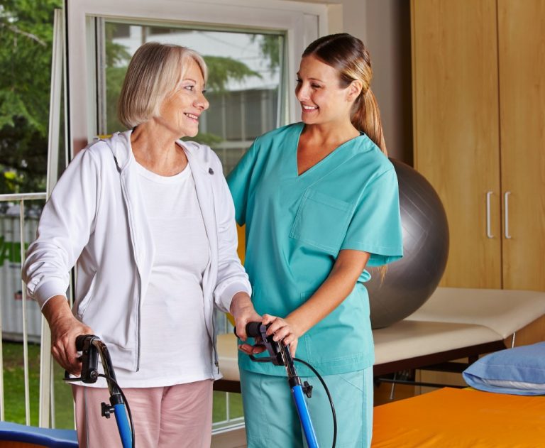 Elderly Woman Assisted by Caregiver