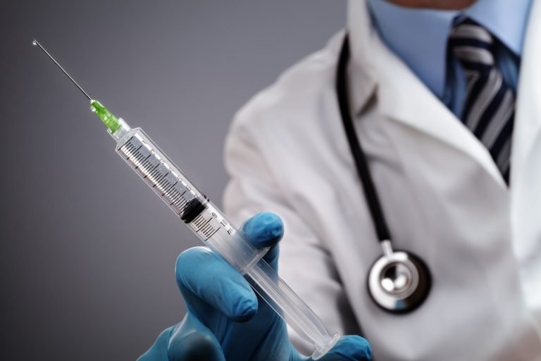Doctor holding a syringe